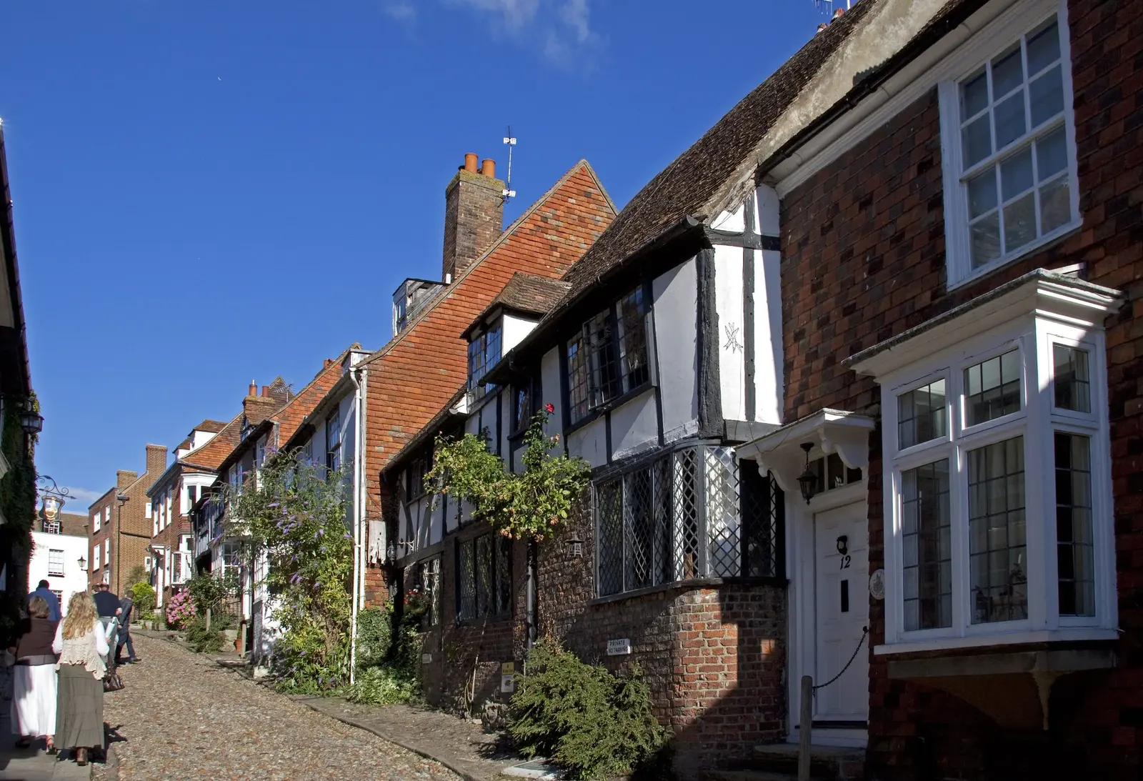 Timber-framed houses and brick buildings along cobbled Mermaid Street in Rye.