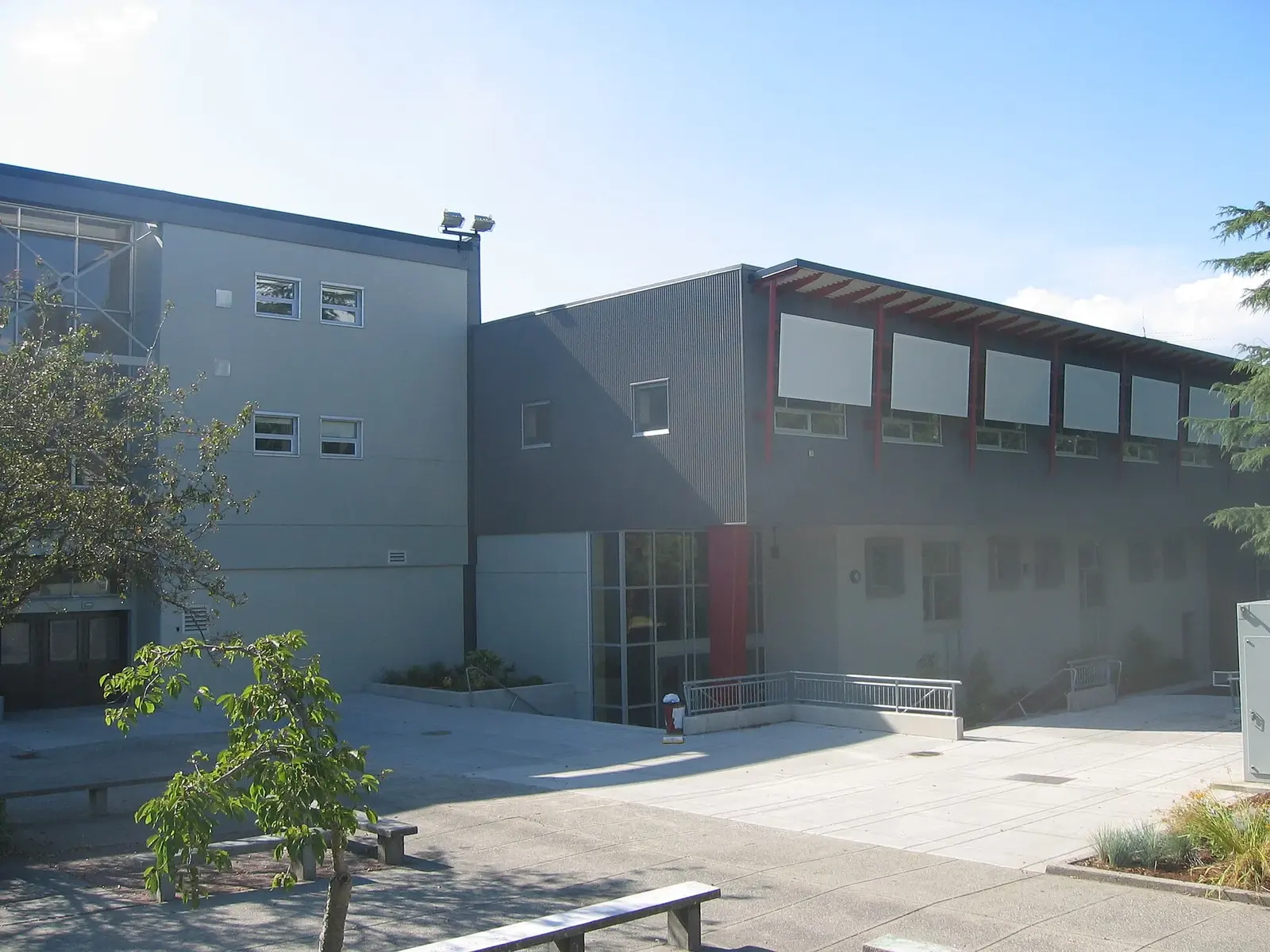 Old Eric Hamber Secondary School building with red structural beams.