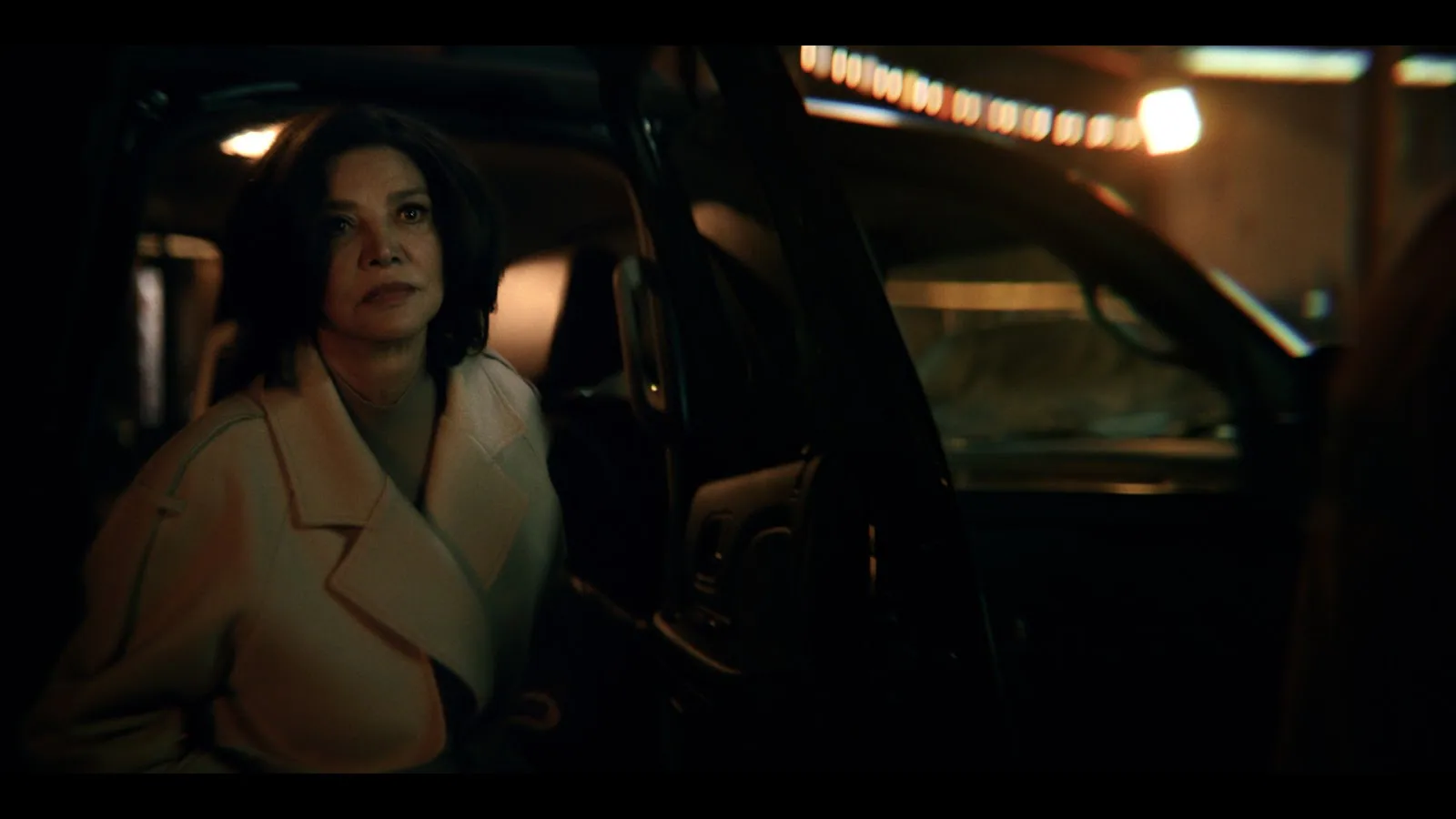 Cristin Milioti as Sofia Gigante in a tense confrontation scene from The Penguin, dark Gotham interior behind her